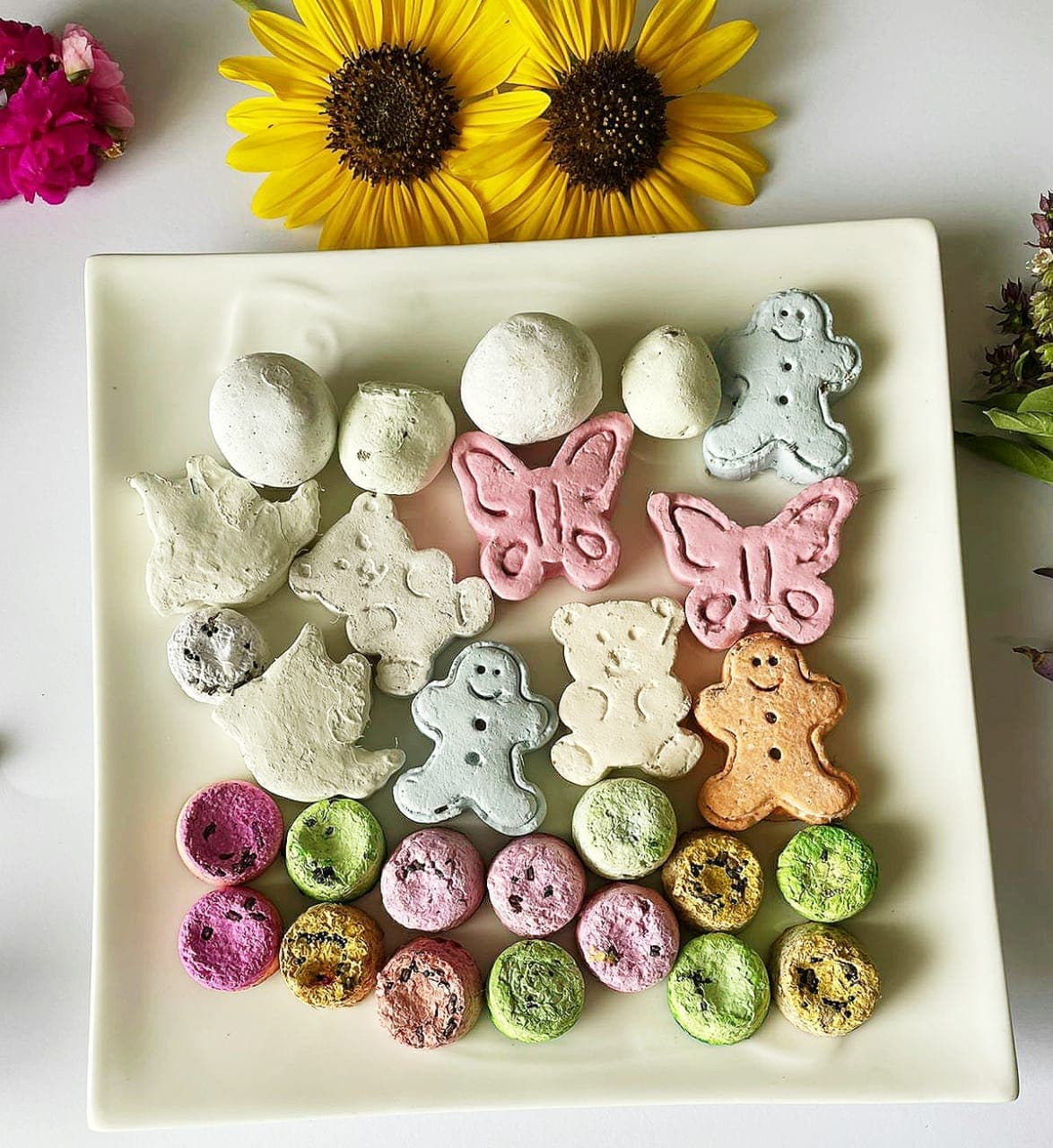 Colorful seed bombs molded into butterflies, bears and gingerbread shapes